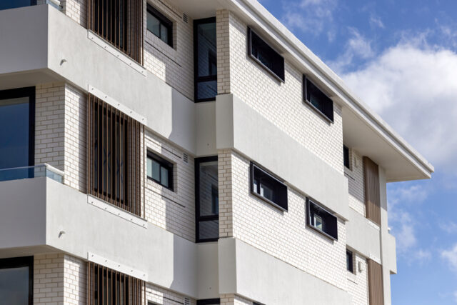Brand new, modern apartment building, background with copy space